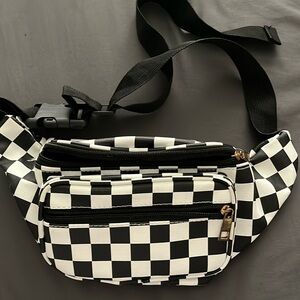 This is a black and white print fanny pack that has not been used at all.